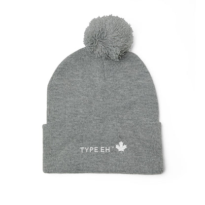 Embroidered Pom-Pom Knit Cap — Cozy Winter Beanie with Subtle Leaf Logo